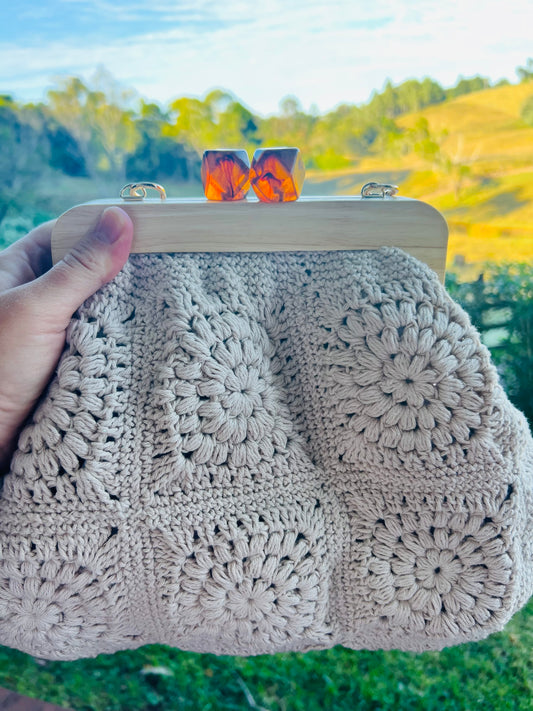 Hand- Crocheted Clutch Bag with Wooden Frame and Amber style kiss lock.